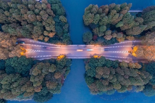 Aerial photograph of a bridge connecting two tree-covered islands