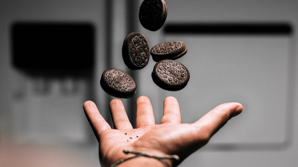 Hand throwing Oreos in the air