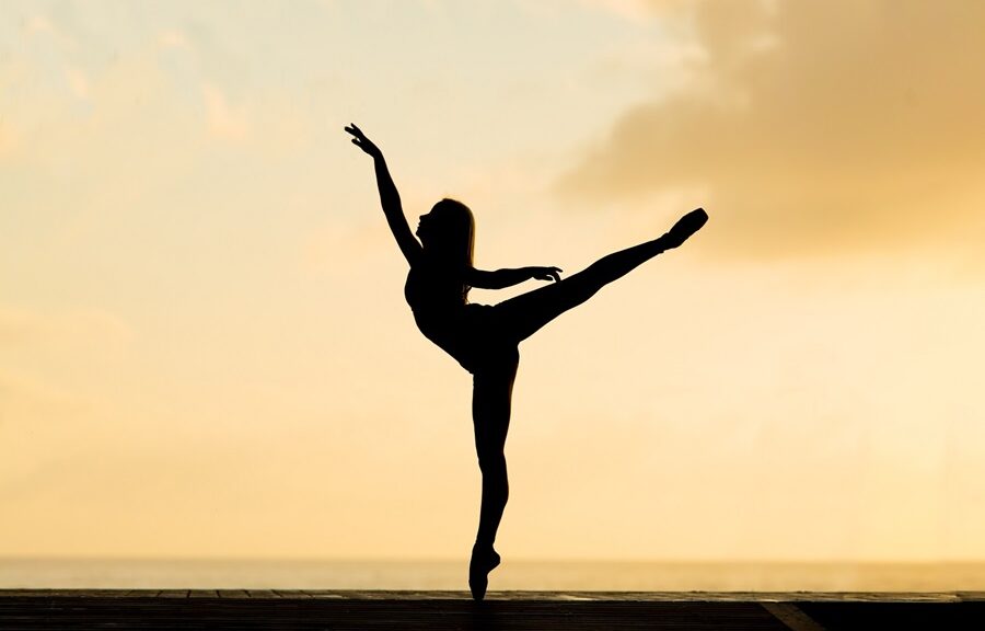 Woman doing ballet in front of sunset